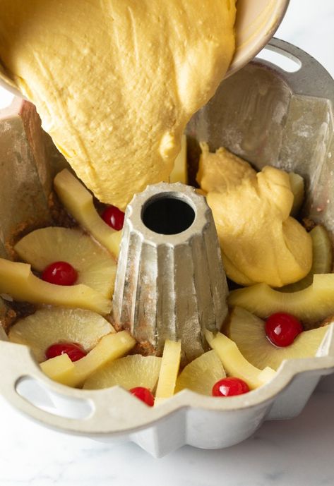 Pouring yellow batter over slices of pineapple and cherries lining the top of an upside down bundt pan. Pineapple Upside Down Bundt Cake Recipe, Best Bundt Cake, Pineapple Upside Down Bundt Cake, Pineapple Upside Down Bundt, Upside Down Bundt Cake, Easy Bundt Cake Recipes, Lemon Cupcake Recipe, Easy Bundt Cake, Cream Cheese Sugar Cookies