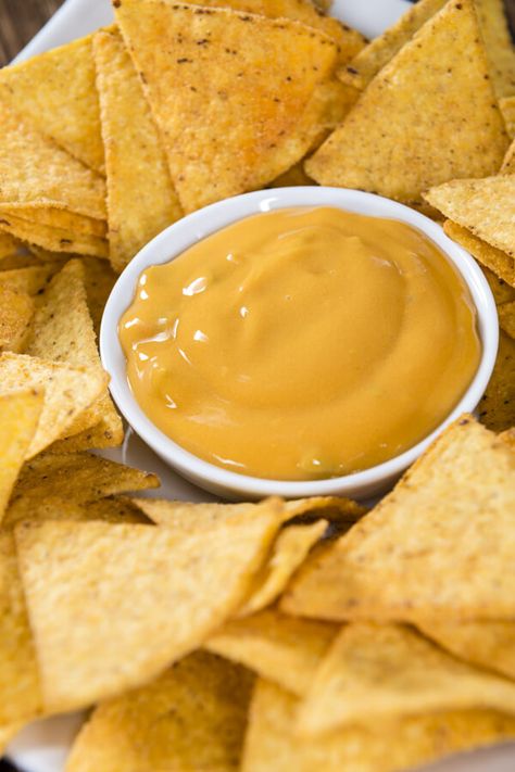 Copycat Disney's Fiesta Fun Center Nacho Cheese Dip | CDKitchen.com Yellow Cheese Dip, Nacho Cheese Dip Recipe, Velveeta Cheese Sauce, Nacho Cheese Dip, Cheese Nachos, Nachos Cheese Dip, Nacho Dip, Tortilla Chip Recipe, Cheese Dip Recipe