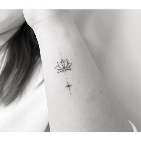 Minimalist lotus flower and north star tattoo on the Lotus Small Tattoo Simple, Lotus Star Tattoo, Small Tattoos Lotus Flower, Lotus Tattoo Wrist Small, Minimalist Lotus Tattoo Ideas, Tiny Tattoos Lotus, Lotus North Star Tattoo, Lotus Flower On Wrist, Lotus Flower Ankle Tattoo For Women