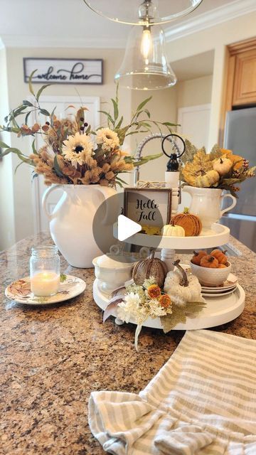 Sheila on Instagram: "Fall kitchen views! My favorite vignettes for fall include fall florals, candlelight, garden flowers and pumpkin muffins! If you watch the whole minute, you'll see I enjoy changing things up sometimes! Do you enjoy changing up your kitchen too? 

It's been a wonderful weekend, the weather is fantastic, feeling chilly at night even! I'm so happy our little garden has a few blooms to enjoy too! I hope you had a great weekend!

Fall faux florals,pear artwork, sunflower plates @HobbyLobby
White large vase, barstools @potterybarn
Pumpkin cake dome @homegoods
Fall pillow @pillowpanels

Let me know if you have questions about any other items, I'll share what I can!

#fallstyle
#fallkitchen
#falltieredtray
#tieredtraysaremyjam
#traystyling 
#fallhome
#fallhomedecor
#pumpkinse Pear Artwork, Fall Ties, Encourage Each Other, Red Tray, Kitchen View, Sweet Kitchen, Fall Pillow, Cake Dome, Fall Kitchen Decor