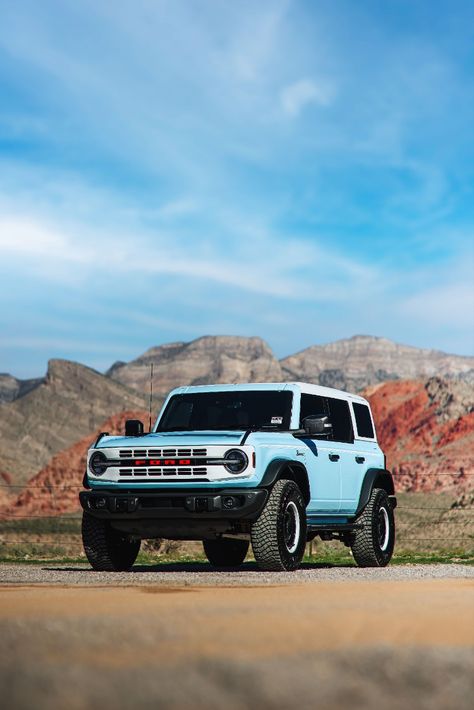 2023 Ford Bronco Heritage Edition in Robins Egg Blue Parked On A Dirt Road During The Day With Red Rock Mountains In The Background. Blue Ford Bronco Aesthetic, Blue Bronco Aesthetic, Outer Banks Bronco, Bronco Ford 2023, Ford Bronco Heritage Edition, Bronco Ford Aesthetic, Light Blue Bronco, Baby Blue Bronco, Ford Bronco 2023