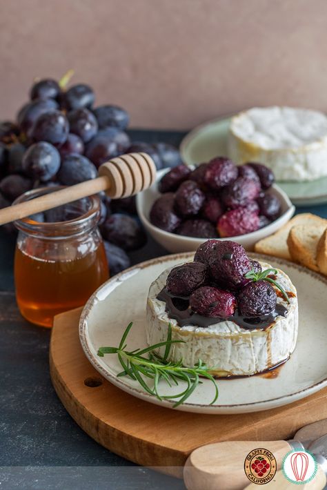 The holidays are approaching, and this baked brie will be a delicious and beautiful looking appetizer to include in your recipes. Black California grapes are roasted and later coated with a balsamic and honey reduction. The final festive touch is given by adding fresh rosemary as a garnish. Baked Brie With Roasted Grapes, Baked Brie And Grapes, Roasted Grapes, Holiday Roasts, Vinegar And Honey, Balsamic Reduction, Charcuterie Recipes, Baked Brie, Gooey Cheese