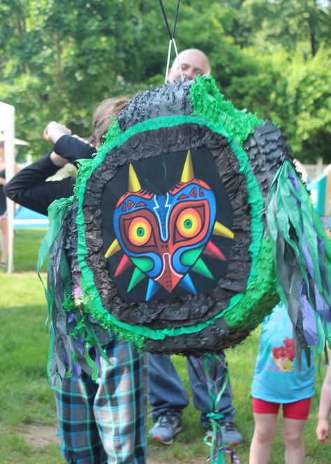 Majora's Mask Piñata for Noah's Zelda Birthday * I revamped an unused piñata from a previous TMNT party. I printed a pic of Majora's mask and added extra crepe paper to fill in the rest Zelda Pinata, Zelda Party, Zelda Birthday, Birthday Pinata, Tmnt Party, Majoras Mask, Theme Parties, 13th Birthday, 9th Birthday