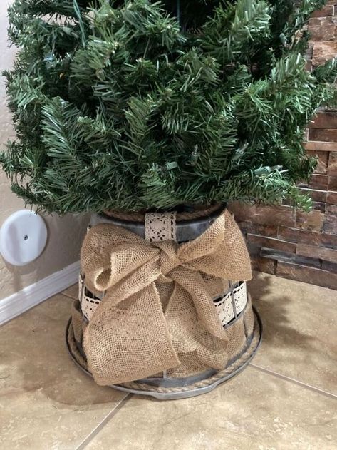 Here is a quick easy Dollar Store tree skirt just in time for Christmas. I have a few trees in my house and I didn’t want to spend money on one of the $20 buckets so I came up with this cute, shabby chic farmhouse tree skirt. It is so simple, you won't believe it! What you’ll need:Laundry basketRibbon (I used lace and burlap but you could use anything)Spray paint (sliver)Black paintRopeScissorsWaverly wax - clear Start by painting the basket sliver. I used this spray paint which is… Laundry Basket Tree Collar Diy, Laundry Basket Tree Collar, Farmhouse Tree Skirts, Basket Tree, Farmhouse Tree, Cheap Christmas Trees, Burlap Tree Skirt, Tree Basket, Burlap Trees