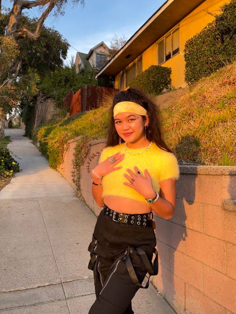 Streetwear, fashion, girl, women, outfit, outfits, girl, aesthetic, Los Angeles style, for school, LA, winter, spring, summer, fall, trendy, style, ootd, for girls, inspo, clothing, clothes, yellow, mohair, fuzzy, crop top, black cargo pants, strappy pants, headband, high ponytail, rings, golden hour, stamp liner, necklace, jewelry Black And Yellow Rave Outfit, Yellow Rave Outfit, Streetwear Fashion Girl, Yellow Crop Top Outfit, Aesthetic Los Angeles, Style For School, Fuzzy Crop Top, La Winter, Oc Outfits