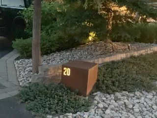 This landscape lighting project was primarily in the back yard, but this photo shows an interesting retro-fit lighting effect we installed in the front yard. Rustic Signage, Signage Light, Illuminated Signage, Park Signage, Hotel Facade, Museum Exhibition Design, Modern Front Yard, Rustic Bowls, Outdoor Signage