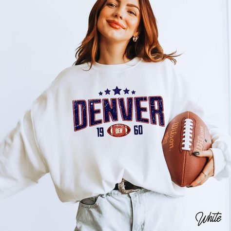 Show your Denver Broncos pride with this vintage varsity-style crewneck! Perfect for Sunday football, tailgating, or as a Broncos fan gift. This cozy Denver sweatshirt is great for Denver game day and football lovers seeking a stylish yet comfy Broncos sweater. Hey there! 😊👋 On the hunt for cozy, stylish sweatshirts? You're in the perfect spot! I'm passionate about creating a shopping experience that's as warm as our products, so if you have any questions or just want to chat, feel free to reach out anytime! 💌💬 ✨ ✨Why You'll Love Our Sweatshirts: ✨✨ ✨Super Cozy! 🌈 Made from a soft 50/50 cotton-poly blend (8.0 oz/yd²) that's perfect for chilly days. ✨Classic Look! 😎 Relaxed, stylish crewneck fit with a timeless design. ✨Built to Last! 💪 Double-stitching in all the right places for du Football Fan Gifts, Sunday Football, Vintage Las Vegas, Ravens Football, Seahawks Football, Raiders Football, Raiders Fans, Patriots Football, Gifts For Football Fans