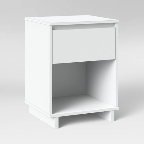 Elevate your sleep space with the simple and chic Modern Nightstand from Room Essentials?. The laminated wood-finish nightstand coordinates easily with any decor style, and it's complemented by a sleek, rectangular silhouette standing at a height of 25.47 inches with convenient closed and open storage options. This bedside table features a smooth top to house your lamp, a lower drawer to secure your bedside essentials and a bottom open cubby that's perfect for books and more. A top drawer withou Tall White Nightstand, Bedroom Lamps Nightstand Target, Target Room Essentials, White Bedroom Nightstands, Cute Bedside Table Decor, Cute Night Stands, Small Nightstand Decor, Cute Bed Side Table, Nightstand Ideas Aesthetic