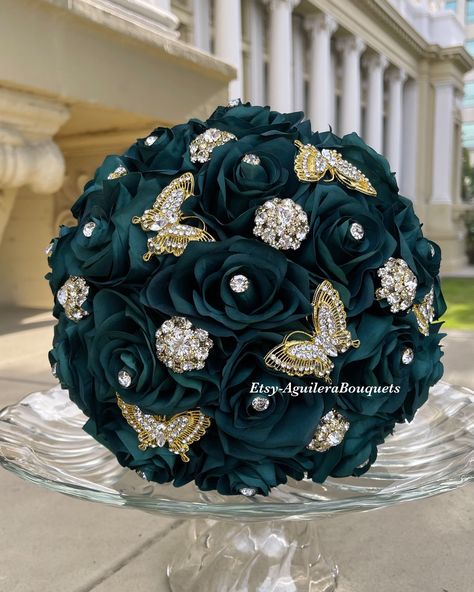 This bouquet is handmade with emerald green roses and gold brooches and butterflies. The design can be changed if requested. I can do it in different colors. Please message me the color.  *This bouquet is 10 inches in diameter* Please contact me with any questions! :) Emerald Green Quince Accessories, Emerald Green Ramos, Chambelanes Outfits Quinceanera Emerald Green And Gold, Emerald Green And Gold Shoes, Emerald Green Quince Damas Dress, Emerald Green Quince Flowers, Gold And Emerald Quinceanera, Emerald Green Quinceanera Bouquet, Emerald Green Quince Dress With Butterflies