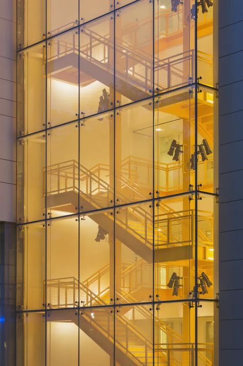 Photo by Jeff Goldberg/Esto The “Big Stair” connects the users to each floor, while offering full light and open views to the neighborhood. At night Racine Avenue glows in the light emanating from both the glass curtain wall of the stairway and the main lobby of the thrust theatre. Stairs Window, Depaul University, Homemade Curtains, Theatre School, Glass Stairs, Window Glazing, Glass Curtain Wall, Glass Curtain, Facade Lighting