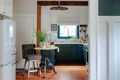 Kitchen with blue cabinetry and trim after renovation. 1920 Bungalow Remodel, Shelf Clutter, 1920 Bungalow, Bungalow Remodel, Blue Cabinetry, 1920s Kitchen, Kitchen Renovation Cost, Reclaimed Beams, Hidden Kitchen