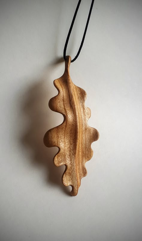 Enhance your style with the timeless beauty of nature captured in this stunning hand carved oak leaf pendant. Meticulously crafted from rich cherry wood, this unique piece of jewelry is a true work of art that will add a touch of elegance and charm to any outfit. Natural Finish: Pendant has been finished with a smooth, glossy surface and protected with linseed oil and beeswax  enhancing its natural beauty and highlighting the warmth of the wood. cherry wood, oak leaf, wooden pendant, nature Wood Carving Keychain, Wood Carving Pendant, Carved Wood Jewelry, Wooden Jewelry Handmade, Oak Leaf Jewelry, Wood Jewerly, Wood Charms, Nature Themed Gifts, Wood Necklace Pendant