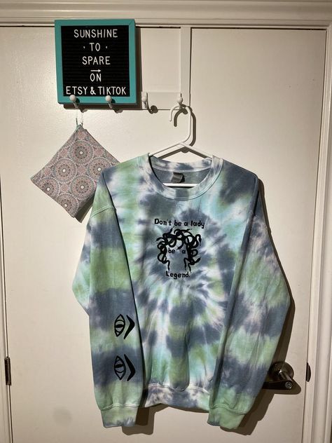 $32.50 + SHIPPING! The story of Medusa is both powerful and heartbreaking. With this hand made design, featured on dual green tie dyed shirts and crewnecks, we hope to channel the inner strength of a true legend! This design is completely unisex and comes in crewneck or long sleeve tshirt styles. Grab one today to represent the legacy of one of the most powerful and misrepresented legends in Greek Mythology. Story Of Medusa, Tshirt Styles, Tie Dye Crewneck, Be A Lady, True Legend, Tie Dye Shirts, Green Tie, Inner Strength, A Lady