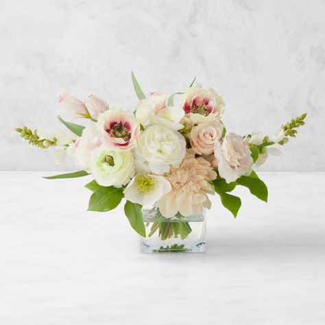 Inspired by the elegant floral motifs of our Famille Rose collection, this arrangement features the same pastel hues and petal shapes as the popular porcelain dinnerware. The faux ranunculus, anemones, lisianthus, dahlias, snapdragons, roses and hellebores are set in a glass vase filled with clear acrylic that creates the impression of water. Each one-of-a-kind bloom, leaf and stem is formed, painted and assembled by hand for remarkable realism. Includes 14 stems of faux ranunculus, anemones, li Small Flower Arrangements For Tables, Small Floral Arrangements, Ranunculus Arrangement, Ranunculus Bouquet, Elegant Wedding Flowers, Rose Floral Arrangements, Small Flower Arrangements, Tennis Table, Silk Arrangements