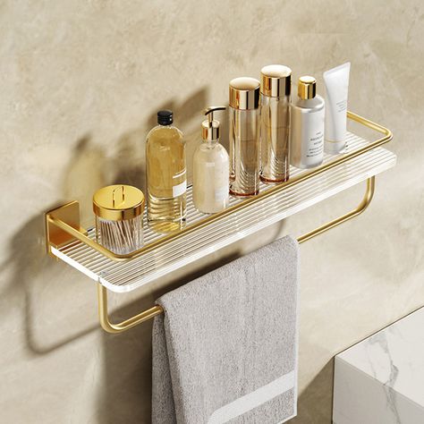 This bathroom wall shelf is designed to enhance your bathroom storage. A contemporary take on the minimalist aesthetic, this wall-mounted rack brings a clean and simple look to your shower room. Crafted of acrylic and finished in gold, it measures 15.75"W x 3.94"D x 3.64"H overall. Featuring a wall shelf and a towel bar, it creates a perfect hanging for towels. - Material: Acrylic- Finish / Color: Gold- Overall Dimensions: 15.75"W x 3.94"D x 3.64"H (400mmW x 100mmD x 90mmH) Lacquered Shelf, Bar For Kitchen, Acrylic Wall Shelf, Gold Bad, Gold Bathroom Accessories, Wall Mounted Storage, Acrylic Shelf, Bathroom Storage Racks, Acrylic Storage