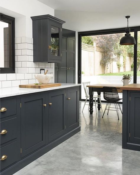 White metro tiles, lots of marble and an amazing polished concrete floor; this is a super stylish Shaker kitchen which works perfectly in this newly renovated Victorian property, where the owners have created a haven of cool tranquillity at the back of their house #deVOLKitchens Dark Grey Kitchen Cabinets, Серая Кухня, Dark Grey Kitchen, Devol Kitchens, Painted Kitchen Cabinets Colors, London Kitchen, Shaker Style Kitchens, Concrete Kitchen, Blue Cabinets