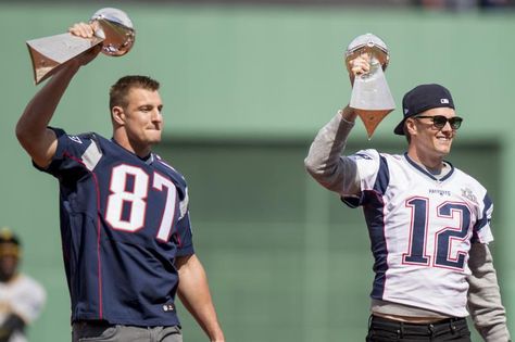 BOSTON, MA - APRIL 3: Tom Brady #12 and Rob Gronkowski #87 of the New England Patriots hold the Super Bowl trophies during a pre-game ceremony before the Boston Red Sox home opener against the Pittsburgh Pirates on April 3, 2017 at Fenway Park in Boston, Massachusetts. (Photo by Billie Weiss/Boston Red Sox/Getty Images) Tom Brady And Rob Gronkowski, Rob Gronkowski Patriots, Nfl Divisions, Super Bowl 52, Thanksgiving Football, Dez Bryant, Pre Game, Rob Gronkowski, The Ledge