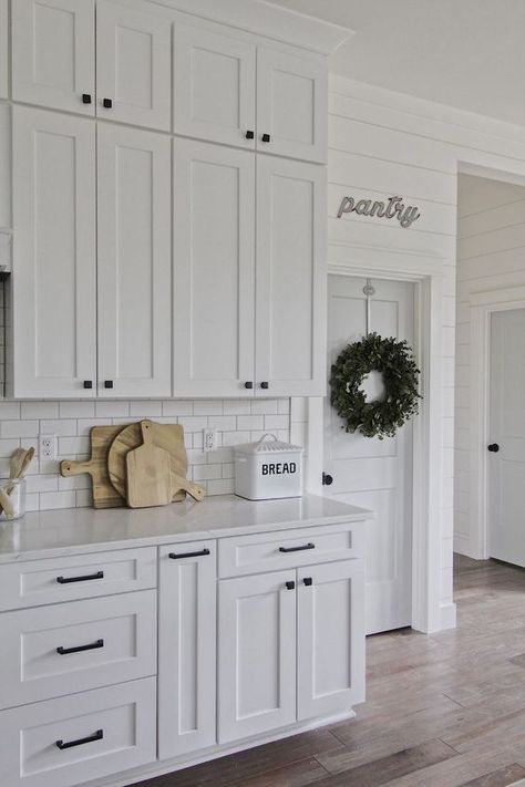 White cabinets, black hardware, wood accents + we like the flooring Modern Farmhouse Kitchen Cabinets, White Shaker Kitchen, Shaker Kitchen Cabinets, Farmhouse Kitchen Cabinets, Kitchen Cabinets Decor, New Kitchen Cabinets, Kitchen Cabinets Makeover, Classic Kitchen, White Kitchen Design