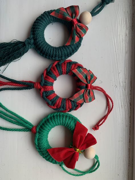 Beautiful Macrame Christmas Wreath Tree Decorations.  These are carefully made using high quality cotton cords and a wooden ring/bead.  Each wreath can be made in a variety of colour combinations, simply choose your design number (photo 2) and your desired colour from the drop down menus at the checkout :)I am always happy to make in any colour so just drop me a message if this is your preference e.g. red and white.The completed decoration measures approximately 6cm in diameter with the tassels/ Macrame Christmas Presents, Macrame For Christmas, Macrame Christmas Decor, Bead Christmas Decorations, Macrame Christmas Ornaments Diy, Christmas Macrame Ideas, Christmas Handmade Decorations, Wooden Bead Wreath, Macrame Christmas Decorations