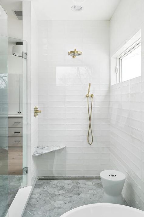 Stunning seamless glass shower boasts white glass stacked tiles fitted with a bras shower kit located over a marble ledge fixed above large marble hex floor tiles. White Subway Tile Bathroom, Subway Tile Showers, Subway Tiles Bathroom, Farmhouse Shower, White Bathroom Tiles, Tile Remodel, Bad Inspiration, Bathroom Tile Designs, Bathroom Shower Tile