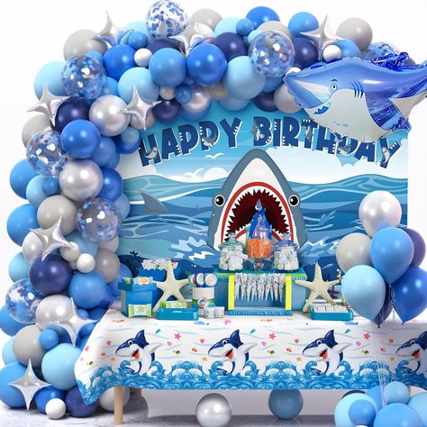 PRICES MAY VARY. 146Pcs Shark Birthday Decorations - If you have a child who loves the ocean and loves sharks, then don't miss this set of shark birthday party decorations. You can get 125 latex balloons (5"+10"+12''), 5 blue confetti balloons, 10 silver star foil balloons, 1 large shark foil balloon, 1 shark backdrop, 1 shark theme tablecloth, 100 dots, 1 roll ribbon (10m), 1 balloon arch strip (5m). The vibrant and stunning shark party decorations will turn your celebration into a marvelous ad Shark Balloon Garland, Shark Birthday Party Decorations, Shark Birthday Decorations, Shark Balloons, Ocean Theme Party Decorations, Sea Birthday Party Decorations, Ocean Themed Party, Shark Balloon, Shark Party Decorations