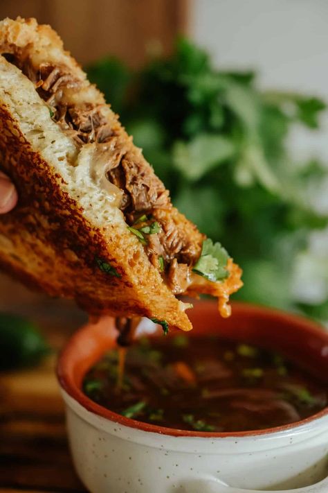 Discover the ultimate comfort food fusion with my Birria Grilled Cheese Sandwich recipe! Combining the savory depth of Mexican Birria de Res with the gooey delight of a classic American grilled cheese, this sandwich is a flavor-packed twist on traditional favorites. Perfect for using up leftover birria and consommé, it's a step above Disneyland's version. Dive into variations with different cheeses, bread, and toppings, and savor expert tips for that perfect golden crust. Leftover Birria, Birria Grilled Cheese, Cheeses Bread, Mexican Birria, Southwest Food, Mexican Sandwich, Grilled Cheese Sandwich Recipe, Cheese Sandwich Recipe, Southwest Recipes