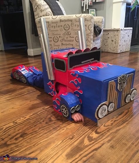 Family Transformers Costumes, Car Costume Diy Cardboard Boxes, How To Make A Cardboard Box Car Costume, Optimus Prime Costume Kids, Optimus Prime Costume Diy, Transforming Optimus Prime Costume, Optimus Prime Box Costume, Transformers Cardboard Costume, Optimus Prime Halloween Costume