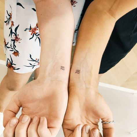 Matching Aquarius symbol tattoos inked on wrists of two best friends by tattooist by Cholo Matching Aquarius Tattoos, Aquarius And Gemini Tattoo Together, Aquarius Sign Tattoo Symbols, Small Zodiac Tattoos Aquarius, Aquarius Symbols, Aquarius Symbol Tattoo, Aquarius Symbol, One Tattoo, Couple Matching Tattoo