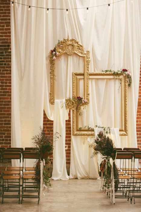 Create this enviable ceremony backdrop with draped fabric, large gold frames  flowers. Source: Sarah Maren Photography. #ceremonysite #goldframes Wedding Ceremony Backdrop Indoor, Makeup Room Decor Wall, Art Deco Party, Cool Makeup, Makeup Vanities, Indoor Wedding Ceremonies, Makeup Room Decor, Decor Ikea, Wedding Ceremony Backdrop