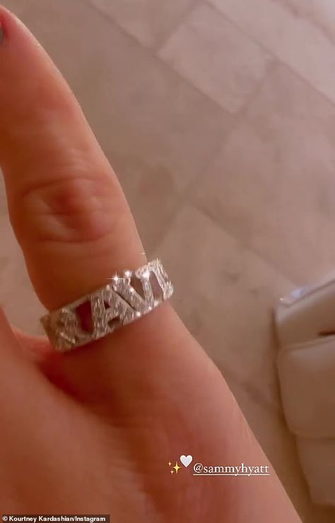 The 43-year-old reality television personality's jewel-filled accessory notably featured the first name of her fiance, Travis Barker, and she made sure to add a sparkling filter to her clip. Kardashian Show, Jenner Family, Travis Barker, Reality Television, Put A Ring On It, Kardashian Jenner, First Name, Kourtney Kardashian, Filter