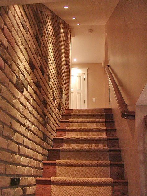 Brick wall going down the stairs make a nice texture for a plain wall. For more renovation tips and ideas, check us out on Facebook with Ottawa General Contractors. Brick Wall Lighting, Dream House Basement, Stairs Basement, Basement Staircase, Basement Entrance, Stair Remodel, Basement Stairs, Basement House, Basement Walls