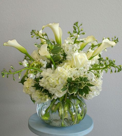 All White floral arrangement using Hydrangea, Calla Lilies, Stock, roses... Hydrangea And Calla Lily Centerpiece, Cala Lilies Arrangement, White Lily Arrangements, Calalilly Centerpiece, Lilly Flower Arrangements, Calla Lillies Centerpieces, Calla Lily Wedding Centerpiece, Calla Lily Arrangement, Corporate Event Centerpieces