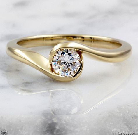 This affordable custom engagement ring gently flows around the diamond like waves on a beach. What colors do you like? How about Rose Gold with a Champagne Diamond? That would still be under $2000! The delicate design of this simple and unique engagement ring looks best with a small center stone. You can even choose a cabochon gemstone. We invite you to contact us. We would love to help you select the right center stone for your custom ring! Dream Wedding Ring Set Gold, Gold Ring Designs For Engagement, Water Inspired Engagement Ring, Elegant Gold Diamond Ring With Round Stone, Wavy Engagement Ring, Modern Gold Ring With Round Stone, Swirl Ring Engagement, Simple Diamond Rings, Wave Engagement Ring