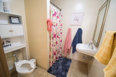 These residents added their own storage over the toilet, in addition to hooks for their towels! Ucf Dorm, Neptune Bathroom, College Bathroom, Dorm Bathroom, Residence Life, College Dorm Room Decor, Dorm Living, College Room, Dorm Life