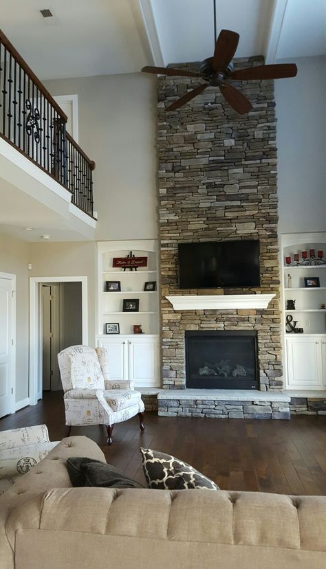 Great room with two story stone fireplace and catwalk.  Boral Bucks County in Southern Ledgestone.  Push back custom recliners are Southern Motion. 2 Story Fireplace, Two Story Fireplace, Marble Living Room, Fireplace Shelf, Tall Fireplace, Stacked Stone Fireplaces, High Ceiling Living Room, Story Stone, Fireplace Built Ins