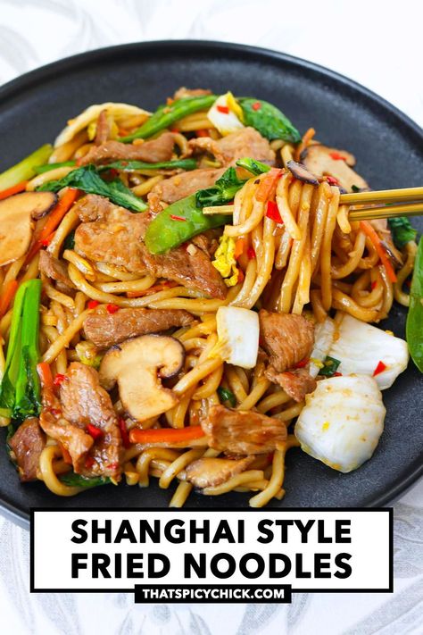 Shanghai Style Fried Noodles is made with chewy thick noodles, juicy pork slices, garlic, chilies, mushrooms, cabbage, other veggies and stir-fried in a mouthwatering savory-sweet sauce! It’s quick and easy to make in 25 minutes, customizable with your favorite protein and veggies, and perfect for busy weeknights! #shanghainoodles #noodles #dinner #betterthantakeout #easyrecipes #stirfriednoodles #stirfry #asianfood #chinesefood | That Spicy Chick Shanghai Noodles, Noodles Dinner, Thick Noodles, Shanghai Style, Asian Noodle Recipes, Pork Stir Fry, Stir Fry Noodles, Fried Noodles, Asian Noodles