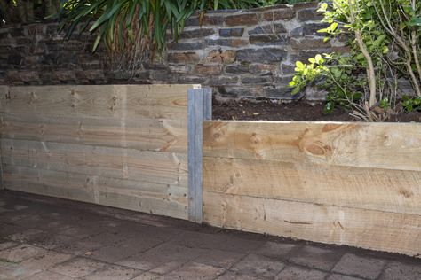 11 Retaining Wall Ideas That Work Hard While Looking Good - Bob Vila I Beam Retaining Wall, Landscaping Retaining Walls Flower Beds, Budget Retaining Wall, Low Retaining Wall Ideas Flower Beds, Diy Small Retaining Wall, Diy Retaining Wall Ideas, Wooden Retaining Wall Ideas, Easy Retaining Wall Ideas Cheap, Diy Retaining Wall Cheap