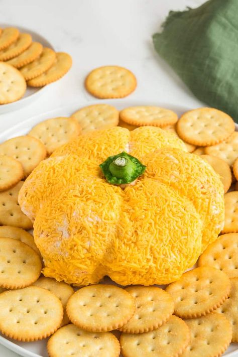 This festive Pumpkin-Shaped Cheese Ball is an easy Fall appetizer you'll love! With just a few simple ingredients, it’s cheesy and rich. This perfect appetizer would be great to serve at Halloween, Thanksgiving, or any Fall party in between! Pumpkin Shape Cheese Ball Recipes, Cheese Ball Easy, Pumpkin Shaped Cheese Ball, Shaped Cheese Ball, Pumpkin Cheese Ball, Fall Appetizers Easy, Fall Appetizer, Thanksgiving Appetizers Easy, Cream Cheese Ball