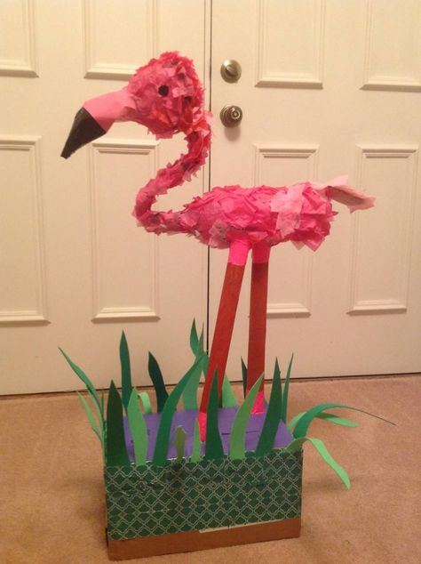 Recycled materials flamingo: gift wrap rolls, 2liter coke bottle, top half of cranberry juice containers, pink gift bag for beak, electrical tape, duct tape, cardboard box, construction paper and tissue paper. Pink Gift Bag, Wrap Rolls, Coke Bottle, Alice In Wonderland Party, Bottle Top, Electrical Tape, Valentine Box, Wonderland Party, Construction Paper