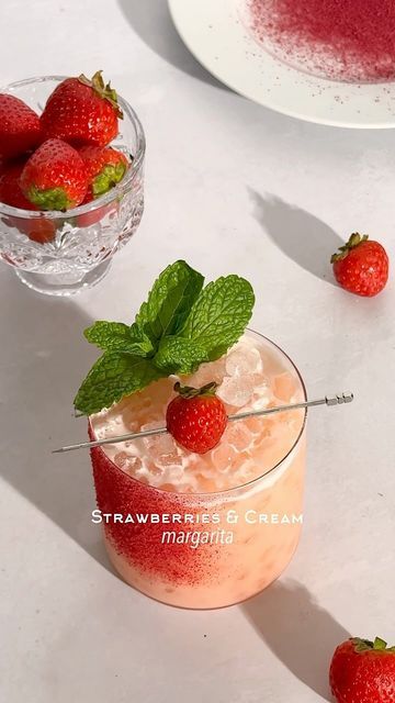 Kelly Pettit on Instagram: "Strawberries & Cream Margarita 🍓☁️ I had no idea that the mandarin cream marg recipe would be such a hit! Thank you for all of the love 🫶🏼 if you were a fan of that recipe, this strawberries & cream marg is for you!  1 1/2 oz tequila 5-6 small strawberry slices 1 oz coconut cream 3/4 oz lime juice 1/2 oz Cointreau 1/2 oz agave  Mocktail Version: 1 1/2 oz Ritual Tequila Alternative 5-6 strawberry slices 1 oz coconut cream 3/4 oz lime juice 1/4 tsp orange extract 1/2 oz agave Garnish: lime juice & crushed dehydrated strawberry  Method: add strawberry slices and tequila to a cocktail shaker and muddle. Add in the rest of the ingredients, add ice, and shake. Rim a glass with a spritz of lime juice (I use a small spray bottle) and crushed dehydrated strawberry. Do