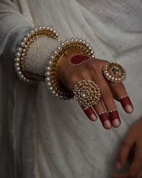 Surabhi didwania on Instagram: "Elevate your style with our exquisite hand stack, a timeless tribute to cultural opulence. Adorn your wrist with our uniquely shaped, intricately detailed silver bangles & kada, handcrafted with precision by our master craftsmen. Featuring the royal pearls design on kada and exquisite meenakari on gold-toned pacheli, each piece looks absolutely adorable. Elevate your elegance with these timeless treasures. Each piece exudes elegance and sophistication, ensuring you make a statement wherever you go. Let the timeless beauty of silver capture every eye.  Adrta : S16682310 Abheri : S17739964 Oversize ring with rubies : S9362261 Floral Ring : S16359340  Shop now on www.mymotifs.com We deliver worldwide 🌍🌎✈️  #finejewellery #gemstones #silverjewellery #indianjew Hand Stack, Oversize Ring, Diy Fabric Jewellery, Fabric Jewellery, Floral Ring, Pearl Design, Fabric Jewelry, Timeless Treasures, Diy Fabric