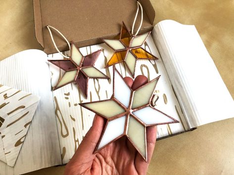 Gift Box of three upcycled stained glass Christmas ornaments! These eco-friendly recycled glass stars can be a lovely suncatcher or part of your Holiday decoration. You might also like https://www.etsy.com/shop/DasimaStudio?ref=seller-platform-mcnav§ion_id=33017073 These stars are made in copper foil stained glass and wire, with vintage finishing details. Stands 11 cm tall /4.3 inch/. The set is gift packed and is ready to placed under the tree! Lovely and unique gift, even just for yourself! - Stained Glass Christmas Ornaments, Star Suncatcher, L'art Du Vitrail, Handmade Holiday Gifts, Stained Glass Ornaments, Stained Glass Decor, Glass Making, Stained Glass Christmas, Glass Stars