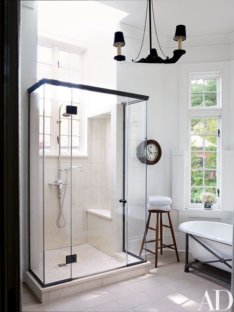 A bath features a vintage tub supported by a custom-made metal base; the 19th-century clock is from Lee Stanton Antiques, the shower fittings are by Waterworks, and the floor is paved with limestone. Darryl Carter, Ad Architectural Digest, Vintage Tub, Shower Fittings, Door Frames, Glass Shower Doors, Bath Room, Shower Door, Glass Shower