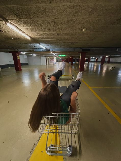 Girl or Women in a shopping trolley riding down the car park aisle white shoes black jeans green t-shirt brunette hair Shopping Trolley Photoshoot, Car Park Photography, Car Parking Photoshoot, Car Park Photoshoot, Metro Pictures, Cute Photo Poses, Friendship Photoshoot, Shopping Trolley, Park Photography