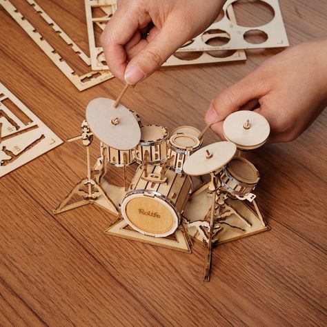 Drum Kit—a fun 3D puzzle project and a stylish home decoration once finished. Great gift for those who love music! Each puzzle comes with LASER-CUT wooden punch-out sheets with easy to follow step-by-step assembly instructions. (When punching out the laser-cut wood pieces, handle with care.) Made with safe, environmentally friendly wood, which makes it a great gift for children or adults. • Laser-cut wood • Assembled Size: 190 x 135 x 110 mm • Puzzle Pieces: 246 pcs 3d Wood Puzzles, Diy Laser Cut, 3d Wooden Puzzle, Smart Toys, Laser Cut Wood Crafts, Jigsaw Puzzles For Kids, Diy Toddler, Drum Kit, Wood Puzzles