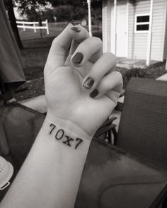 7x70 Tattoo. I'd probably want it just a tiny bit higher on the wrist, like an inch or so, and smaller. Seventy Times Seven Tattoo, 70 Times 7 Tattoo, 7x70 Tattoo, 70x7 Tattoo, Wolf Tattoo Ideas, 7 Tattoo, Tasteful Tattoos, Small Meaningful Tattoos, Tattoo Meaning