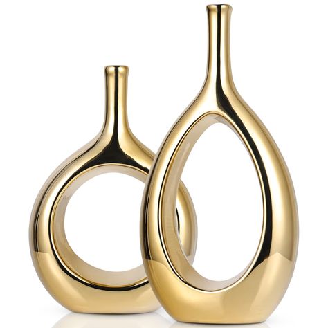 PRICES MAY VARY. 【Glossy Gold Decor Vase】Contemporary home decor is a widely popular mid-Century Modern Ellipse Hollow Vase, These small vases are perfect for your entryway, coffee table, shelf, mantle, accent table, and much more. They will look great no matter the season or Holiday! Create a space in your home with refined Fashion home décor accents, Create a warm atmosphere in your home. 【Modern Gold Vases】Our Light Luxury Ceramic Glossy Gold Vases 2-Piece Set,They come in different shapes an Gold Vase Decor, Small Vases, Gold Centerpieces, Gold Vase, Vase Ceramic, Gold Vases, Luxurious Home, Gold Ceramic, Vase Centerpieces