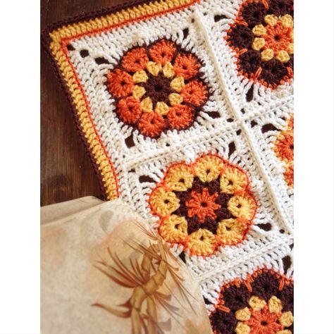 70s style crochet blanket with African Flower Crochet granny squares and bright crochet edging! Crochet 70s Flower, 70s Style Crochet Blanket, 70s Crochet Patterns Blanket, Crochet Blanket 70s, Crochet 70s Blanket, 70s Granny Square Blanket, 70s Crochet Patterns, 70s Moodboard, 70s Crochet Blanket