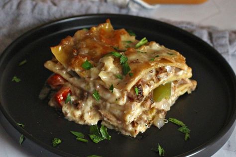 A lasagna recipe layered up with jerk chicken, peppers, onions, and lots of cheese in a creamy sauce inspired by rasta pasta. Chicken Lasagna Recipe, Chicken Peppers, Rasta Pasta, Chicken Lasagna, Steak Sandwich, Boneless Skinless Chicken Thighs, Sauce For Chicken, Jerk Chicken, Bulgogi