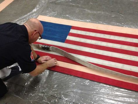 flag-11-1024x768-e1418617660993 Fire Hose Projects, Fire Hose Crafts, Fire Department Decor, Firefighter Room, Diy American Flag, Fire Crafts, Firefighter Home Decor, Firefighter Wedding, Firefighter Gear